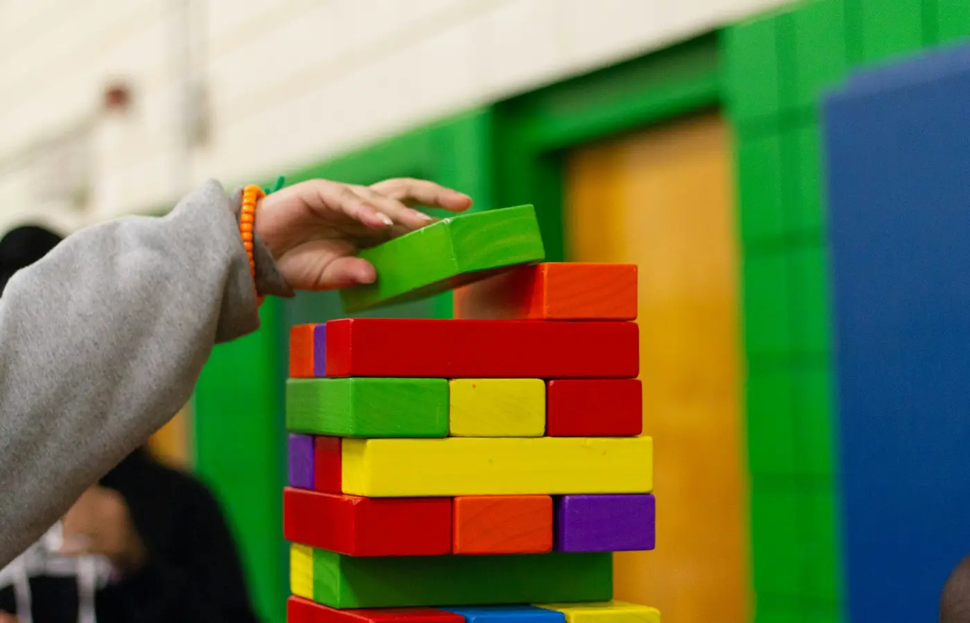 Child connecting colorful building pieces