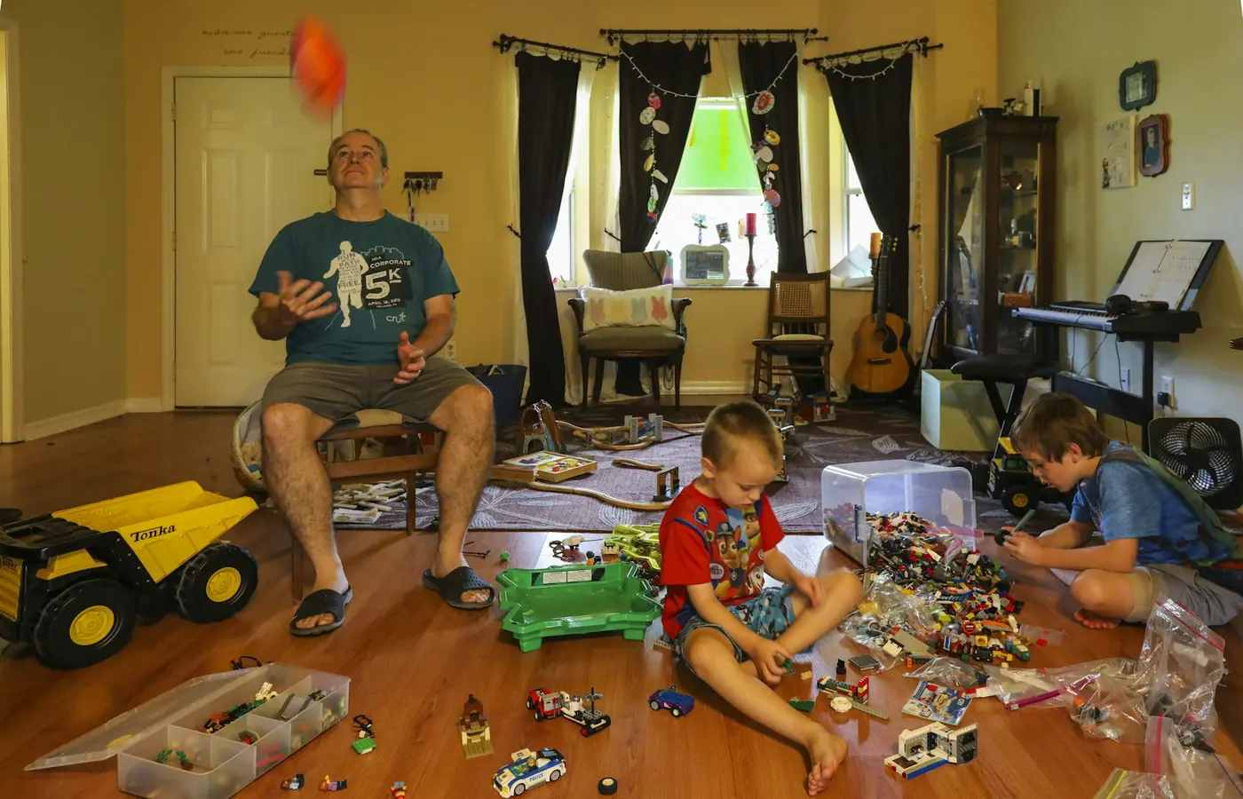 Siblings sorting toys at home