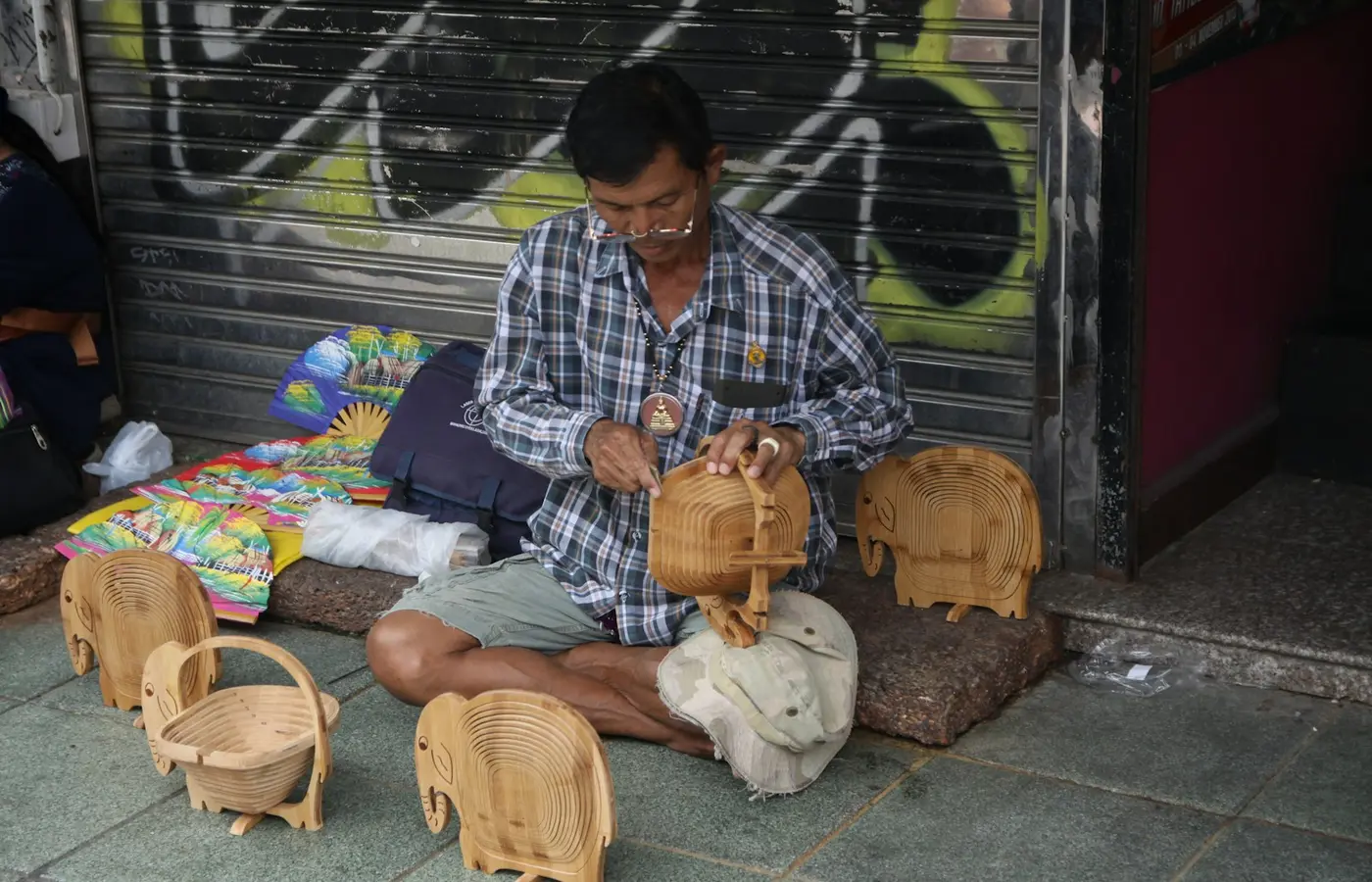 Adult inspecting a secondhand wooden toy