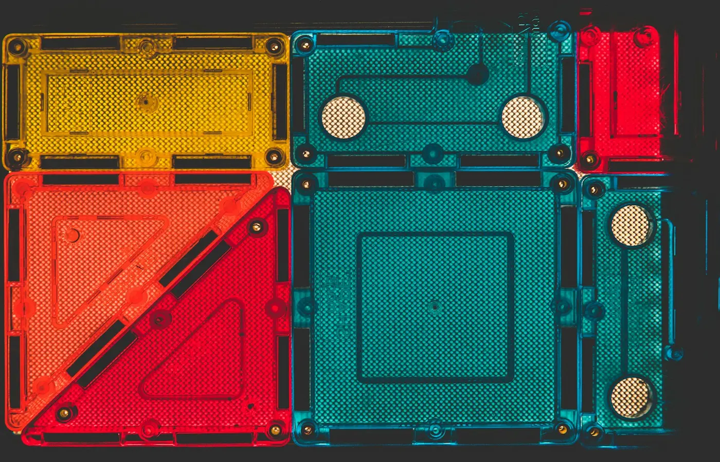 Child building with magnetic tiles