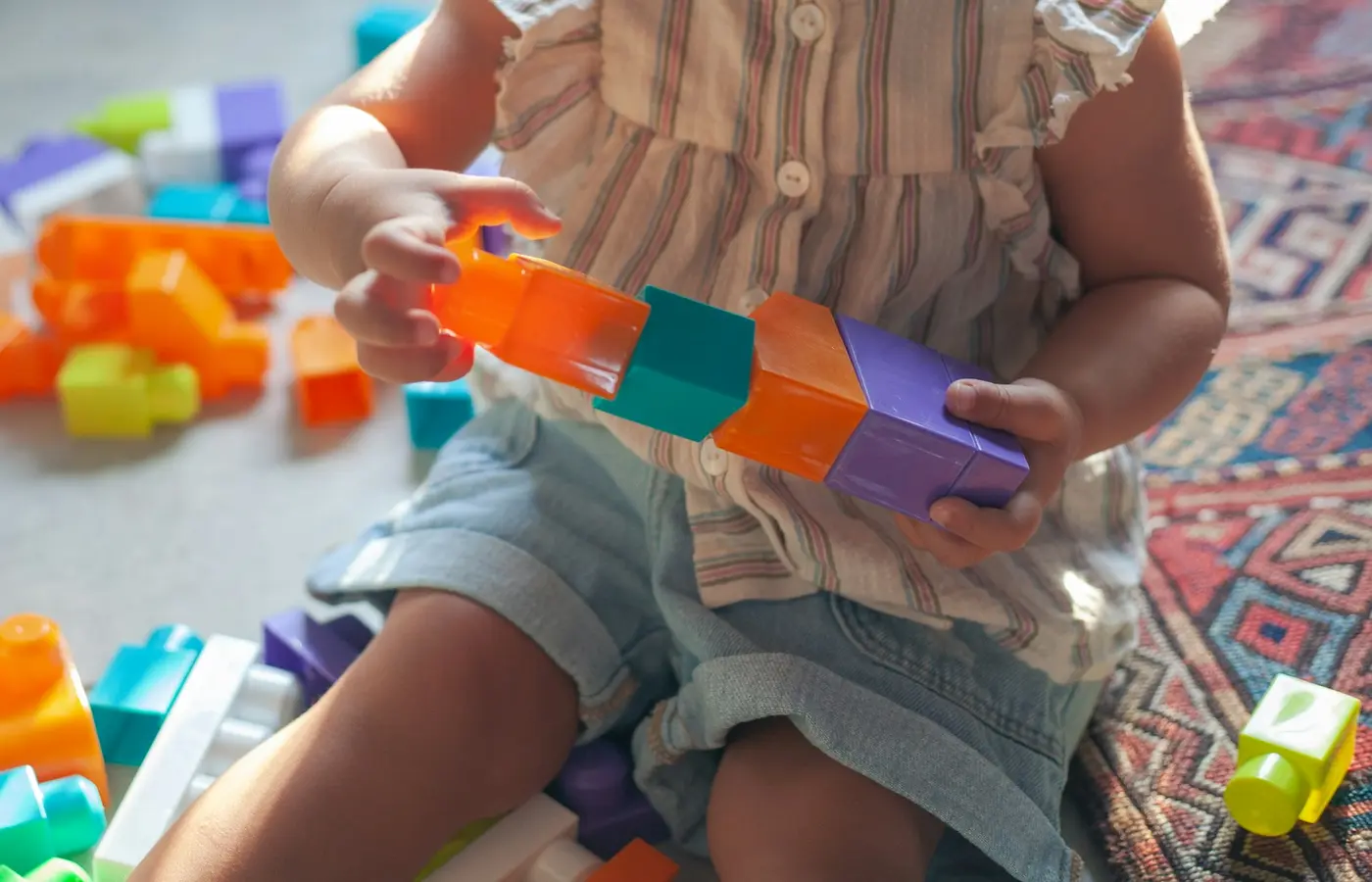 Child taking apart a construction toy